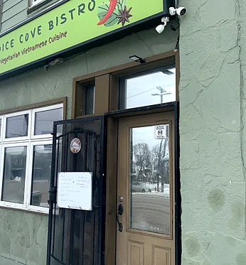 Spice Cove Bistro storefront on Main Street with its green "Spice Cove Bistro, Vegetarian Vietnamese Cuisine" sign