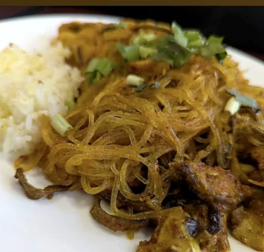 Stir-fried glass noodles with mushrooms and herbs beside steamed rice