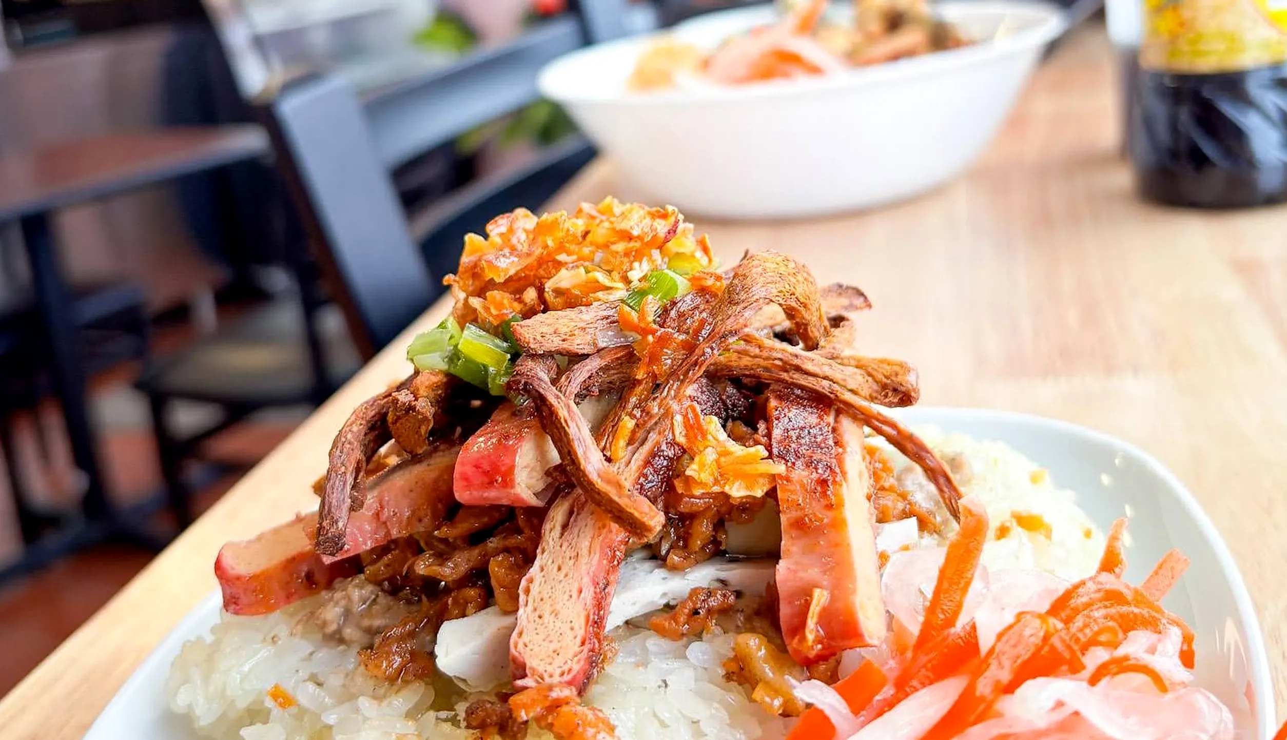 Rice topped with crispy shredded vegetarian topping, scallions and pickled carrot and daikon