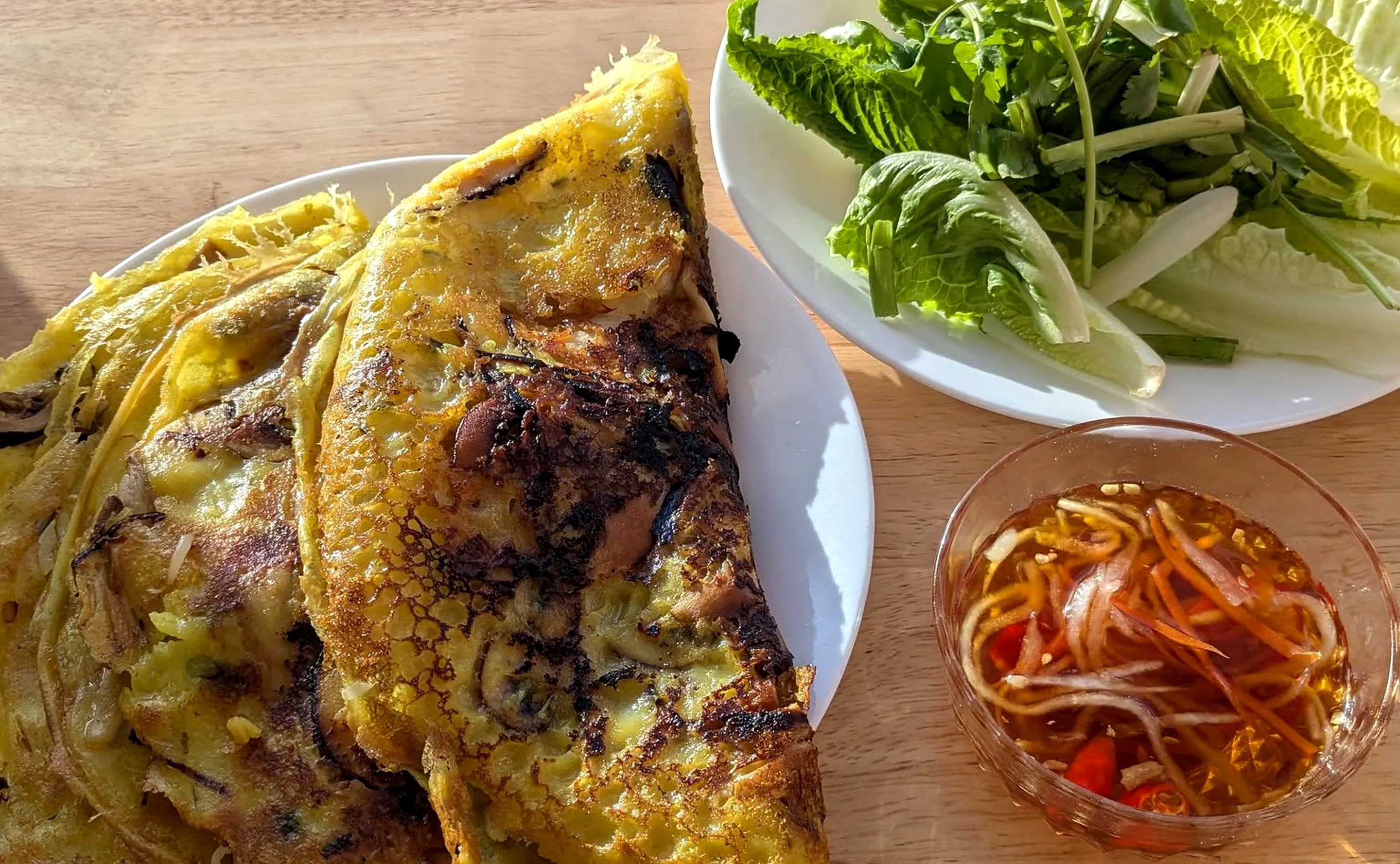 Vietnamese crispy crepe with lettuce, herbs and a dipping sauce
