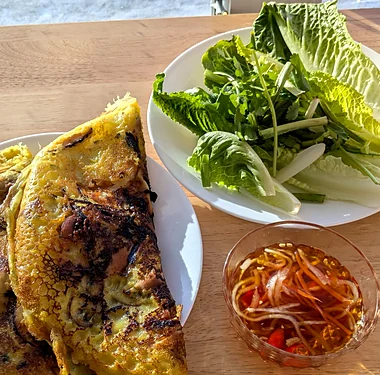 Vietnamese crispy crepe with lettuce, herbs and a dipping sauce
