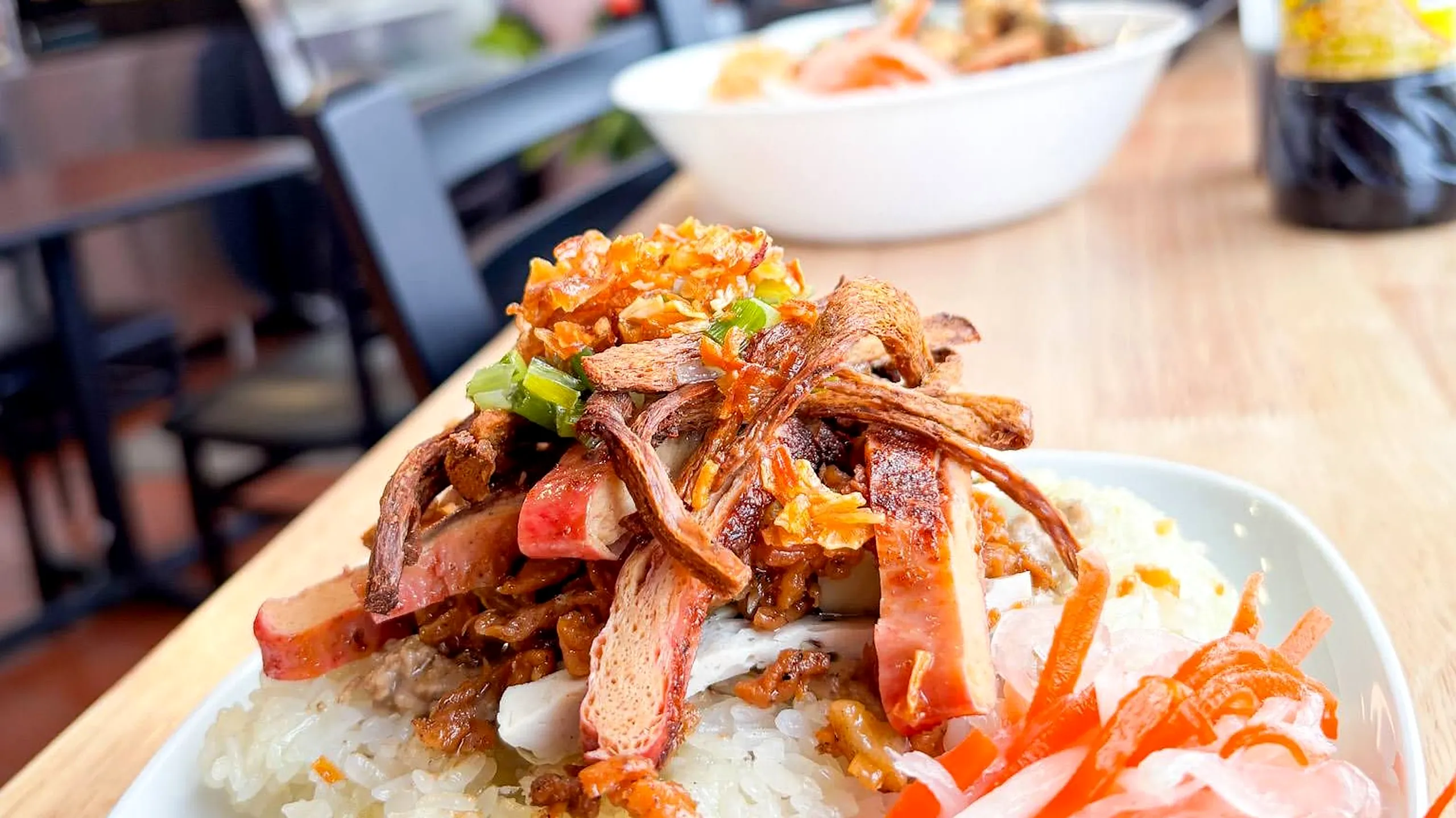Rice topped with crispy shredded vegetarian topping, scallions and pickled carrot and daikon