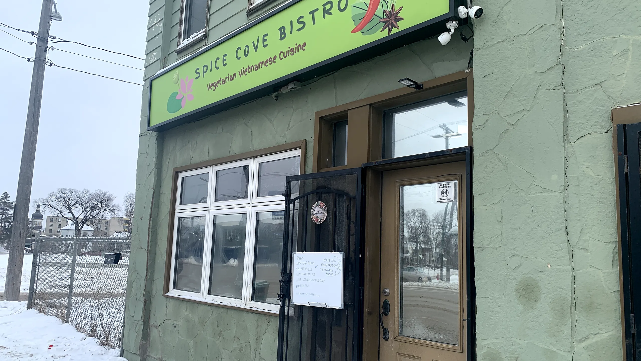 Spice Cove Bistro storefront on Main Street with its green "Spice Cove Bistro, Vegetarian Vietnamese Cuisine" sign
