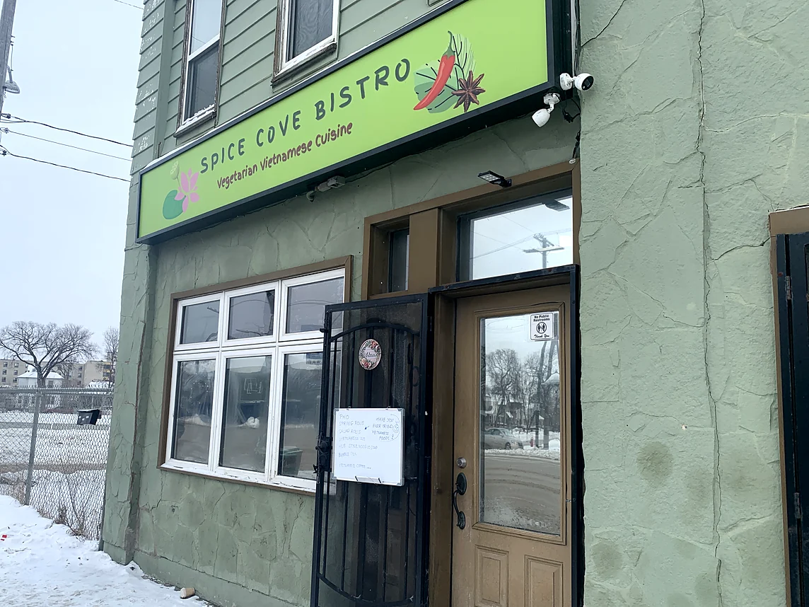 Spice Cove Bistro storefront on Main Street with its green "Spice Cove Bistro, Vegetarian Vietnamese Cuisine" sign